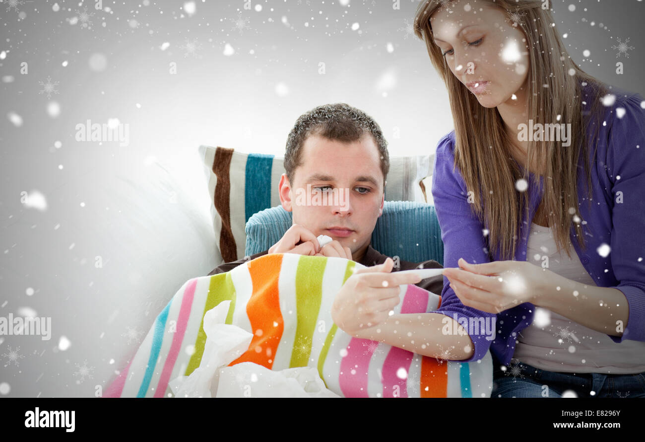 Caring woman check the temperature of her sick boyfriend with a