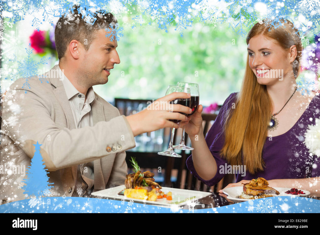 Composite image of cheerful couple having dinner together Stock Photo