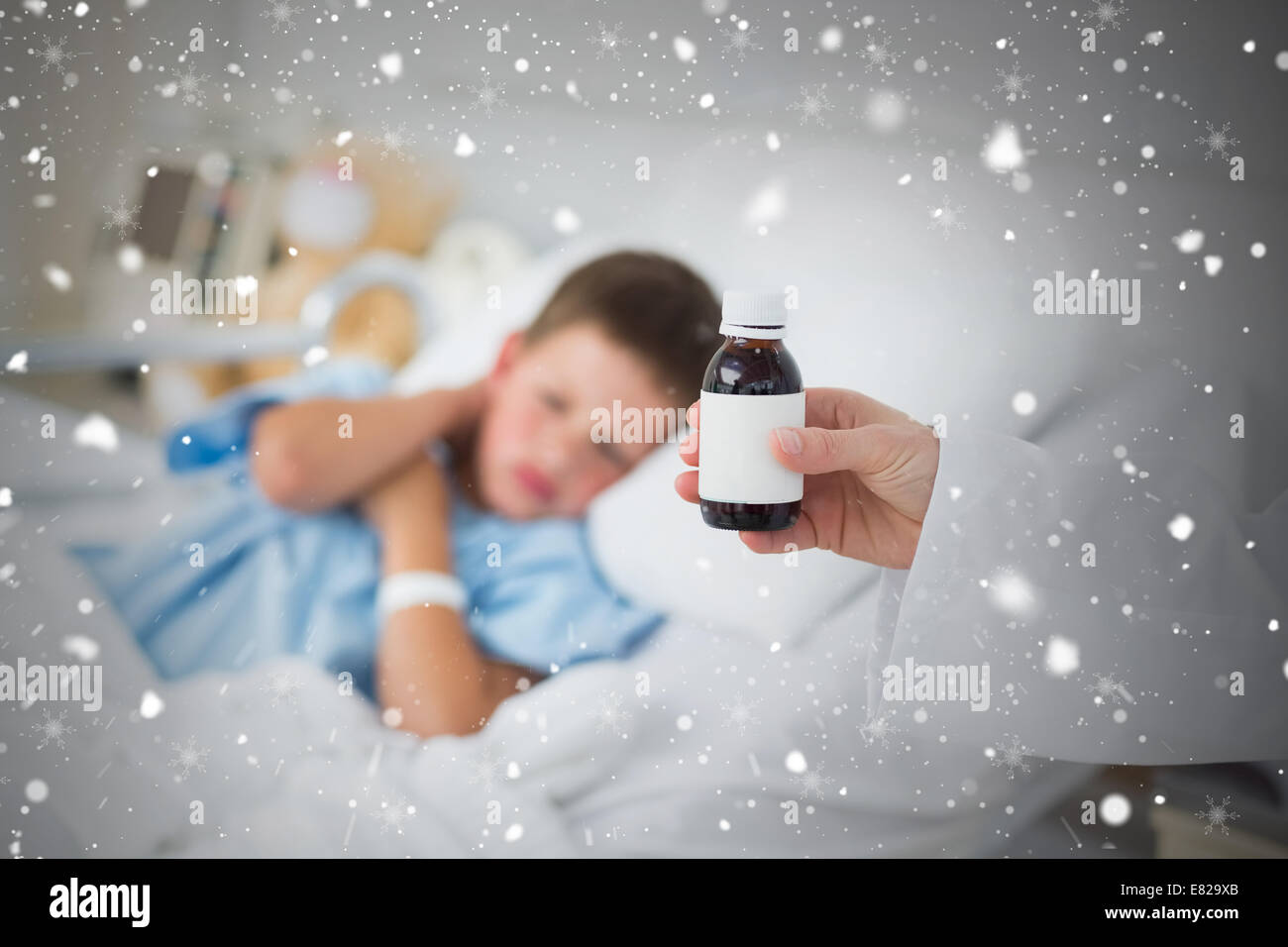 Doctor holding cough syrup with boy in hospital Stock Photo Alamy