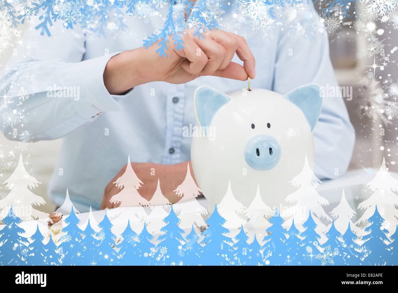 Mid section of a man putting some coins into a piggy bank Stock Photo ...