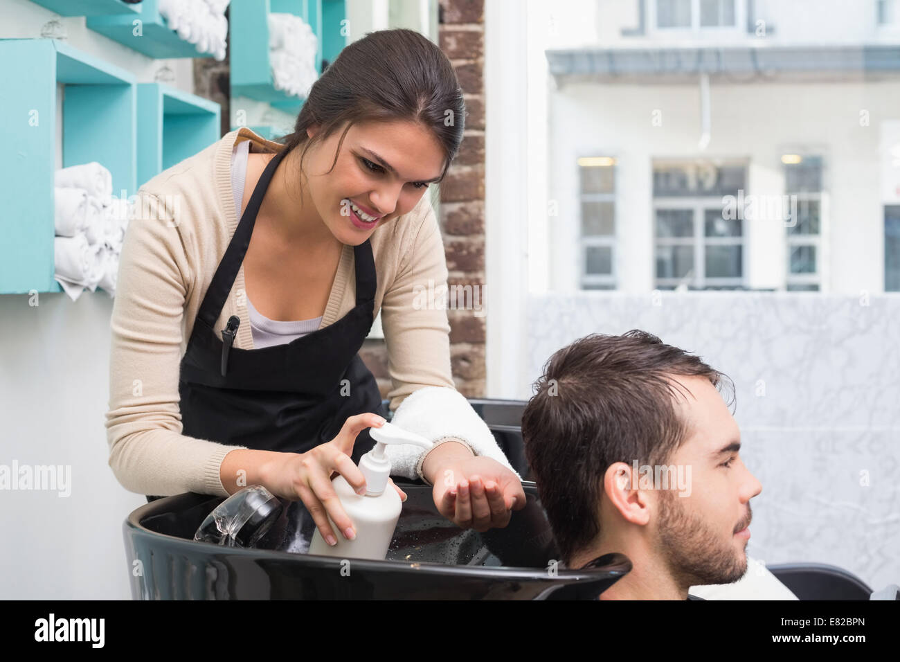 Hair stylist putting conditioner in mans hair Stock Photo Alamy
