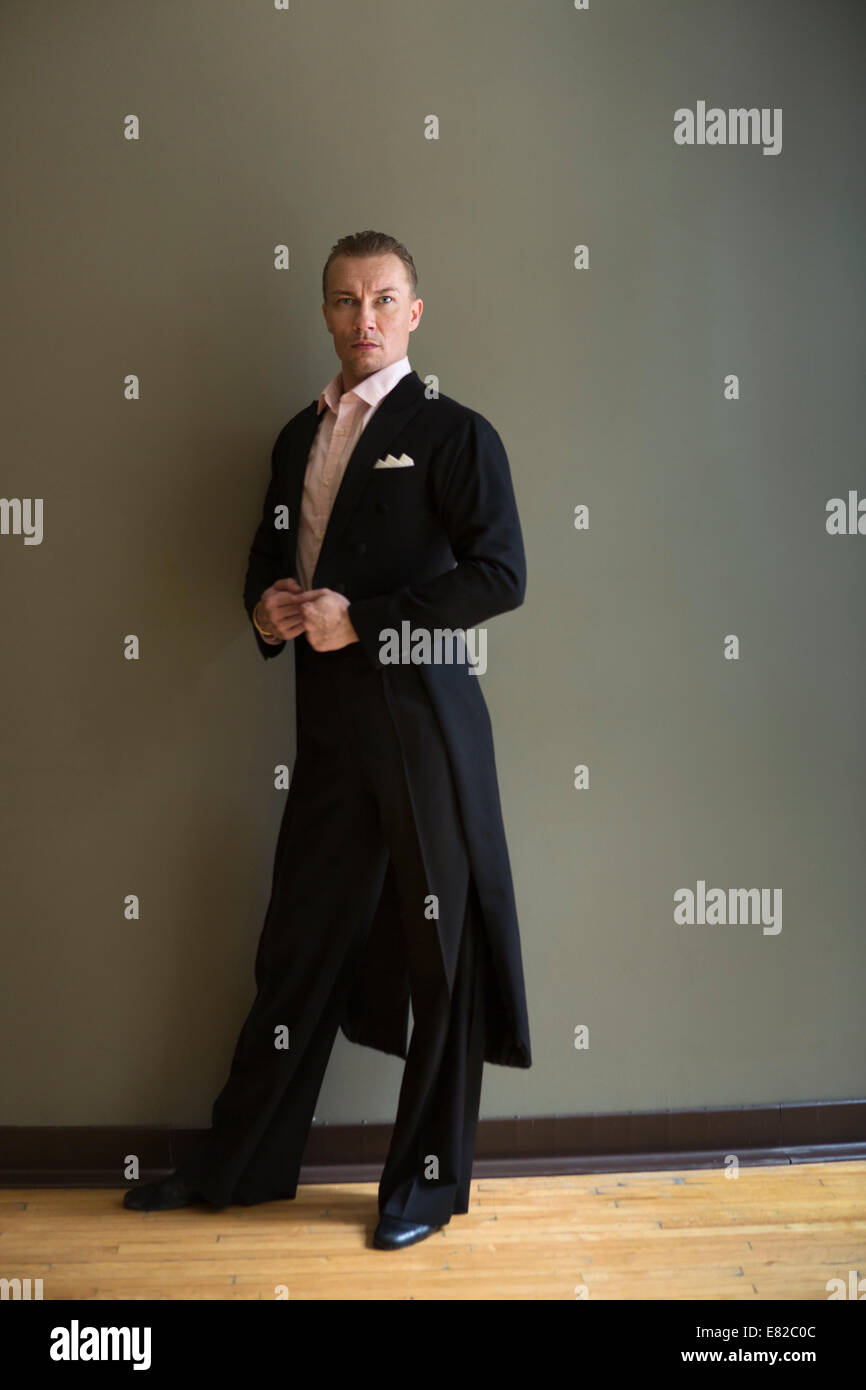 Dancer in dance studio. A man in a frock coat. Stock Photo