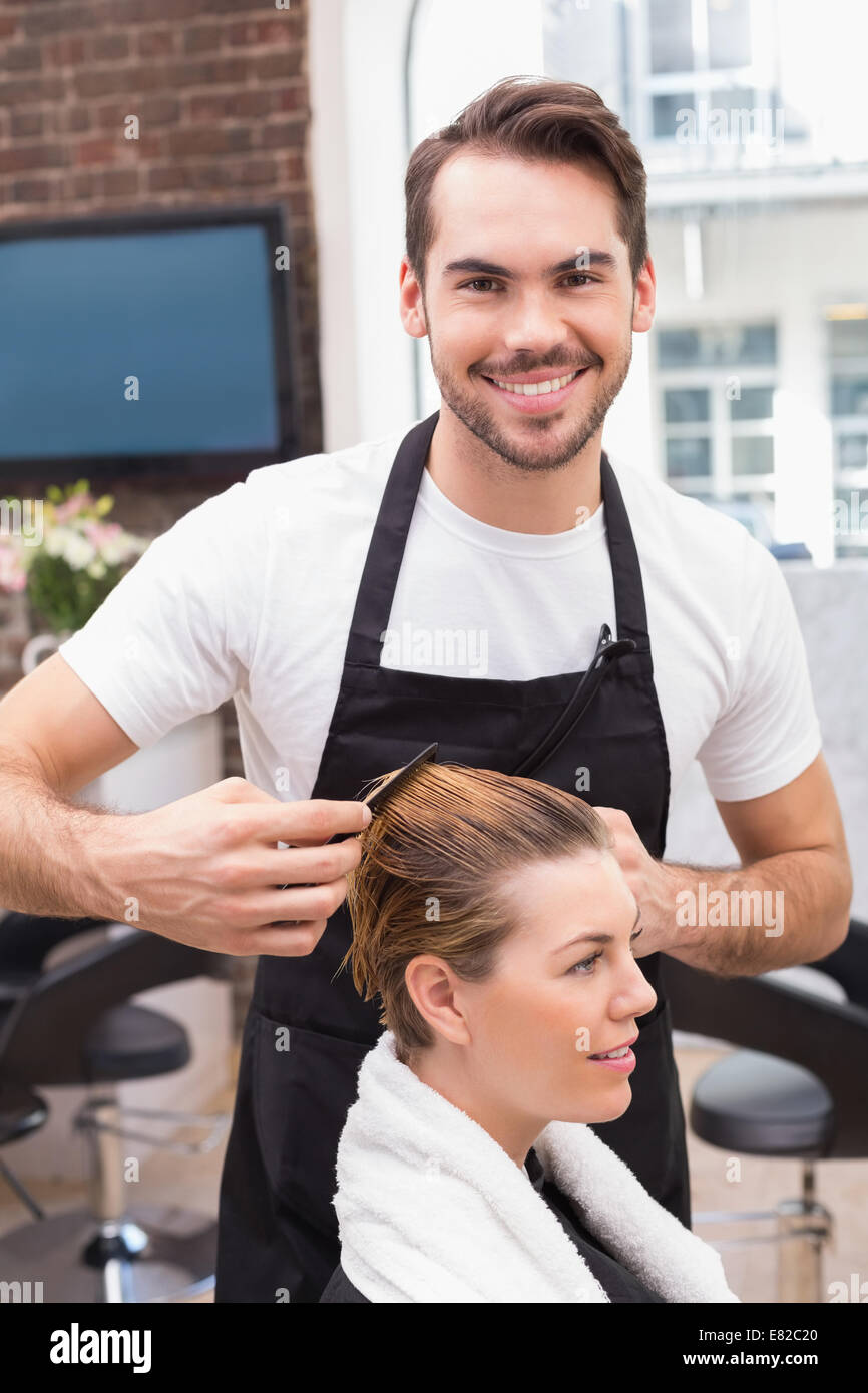 Handsome hair stylist with client Stock Photo - Alamy