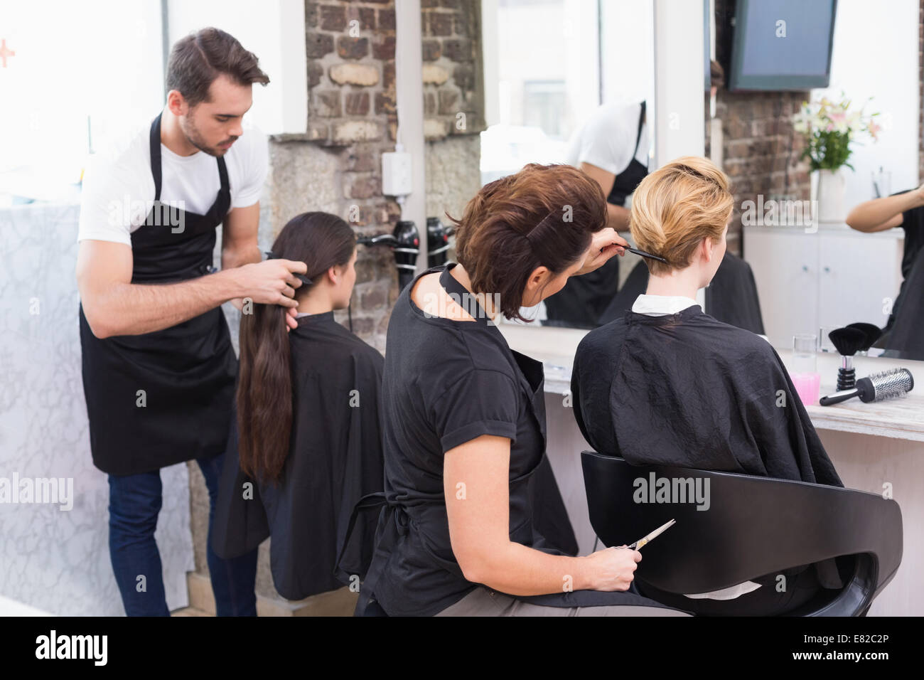 Hairdressers working on their clients Stock Photo Alamy