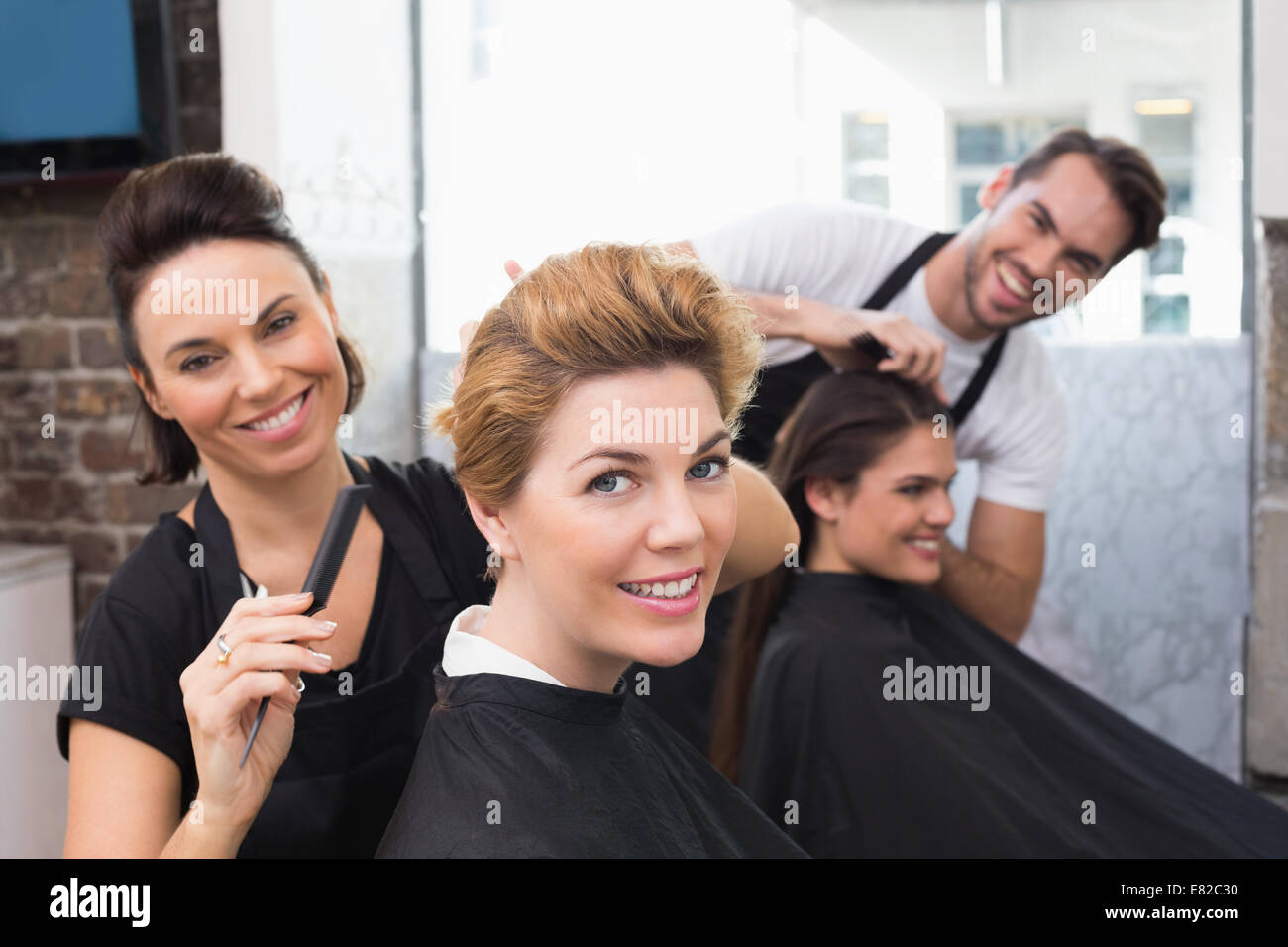 Hairdressers working on their clients Stock Photo Alamy