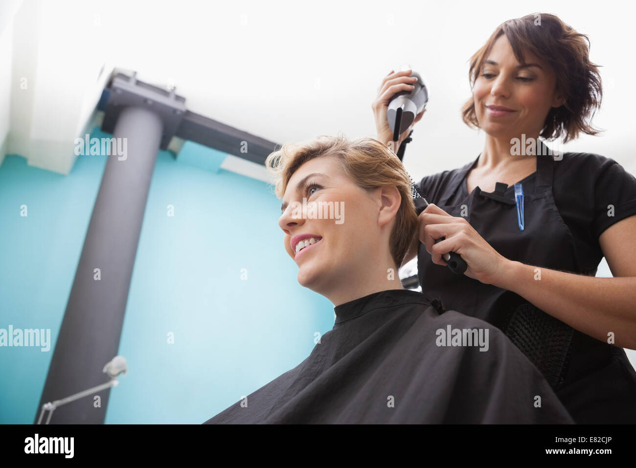 Mature woman drying hair hi-res stock photography and images - Alamy