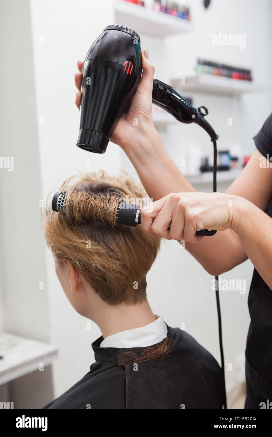 Stylist drying customer hair hi-res stock photography and images - Alamy