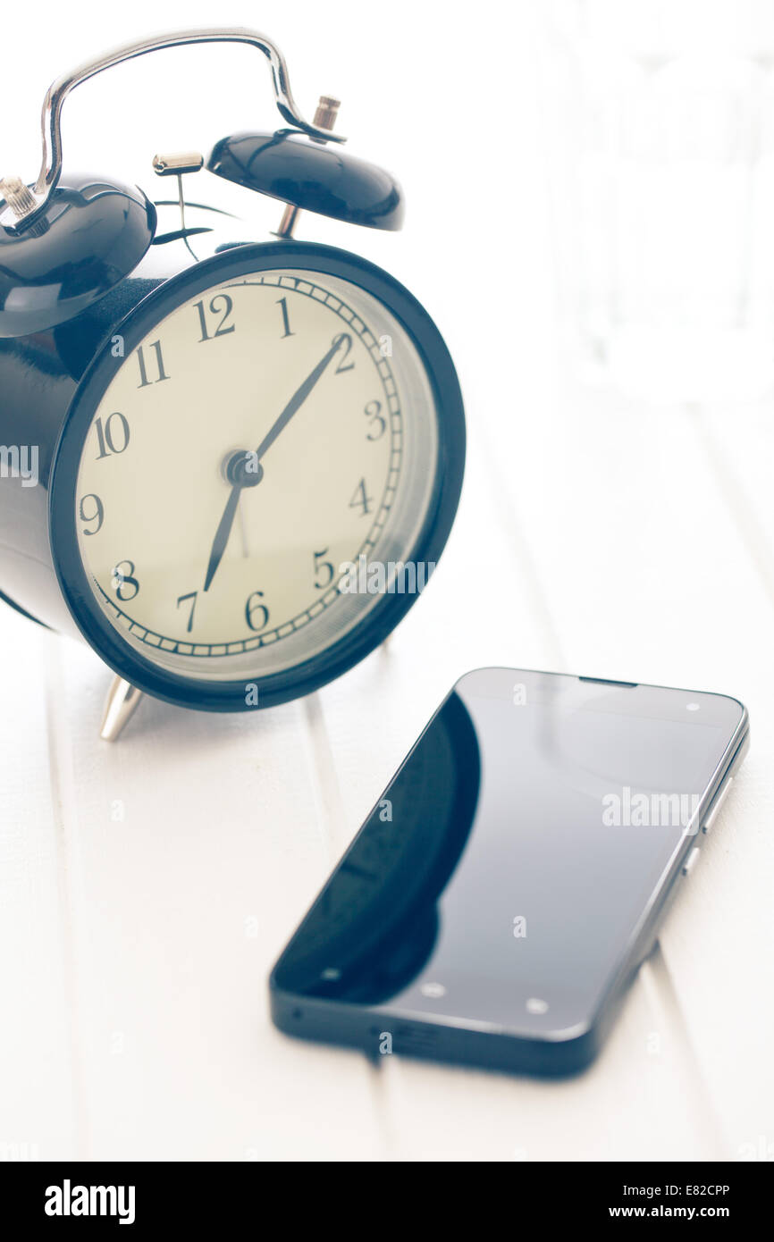 the alarm clock and smartphone Stock Photo