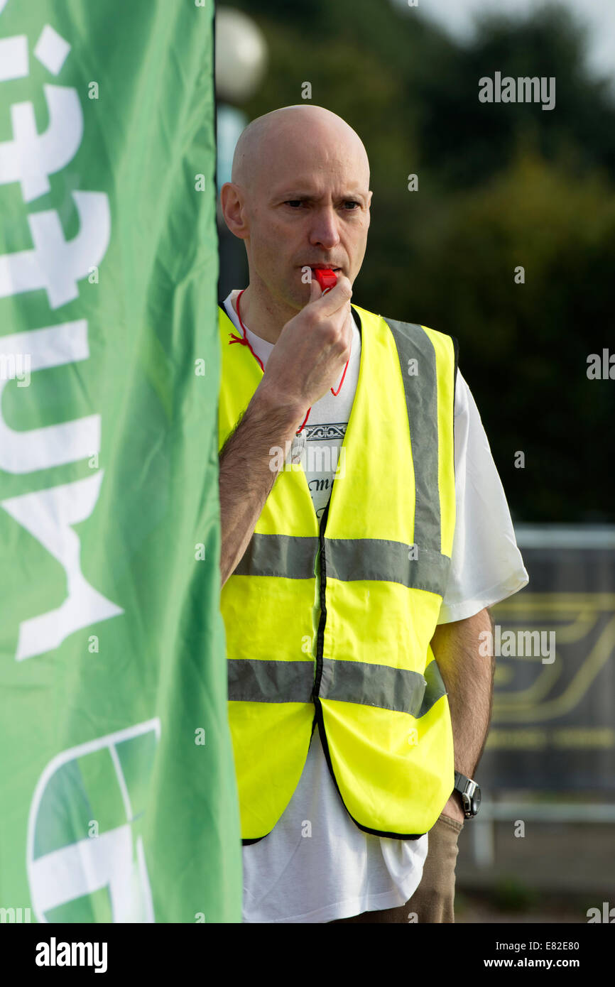 Marshal blowing a whistle to warn spectators during the Warwickshire Triathlon, Stratford-upon-Avon, UK Stock Photo