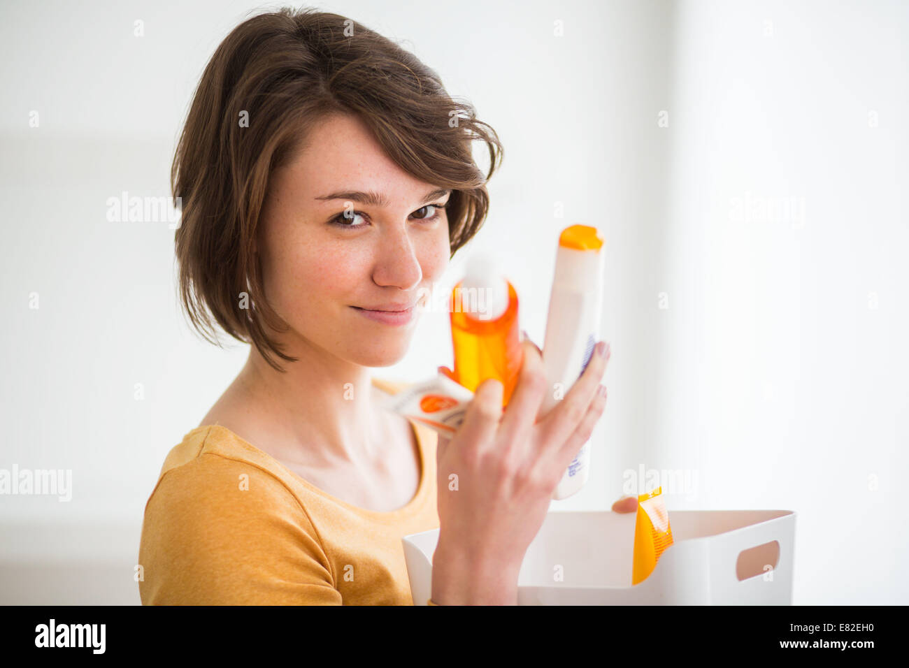 Woman holding different sunscreens. Stock Photo