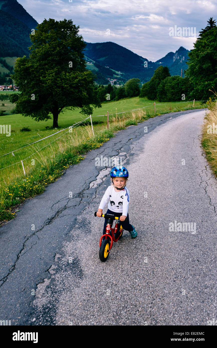 2yrs old girl on a balance bicycle, Kaiserwinkl, Tirol Stock Photo