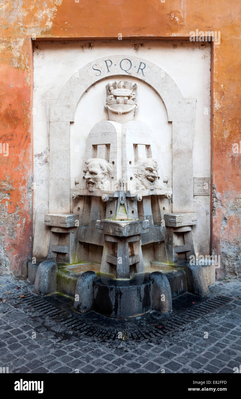 An ornate fountain in Rome, Italy labeled SPQR: Senatus Populusque Romanus, the Senate and People of Rome Stock Photo