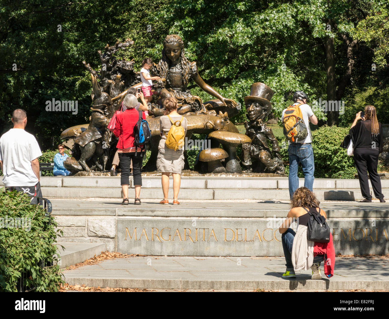 Tourists Flock to Alice in Wonderland Sculpture, Central Park, NYC