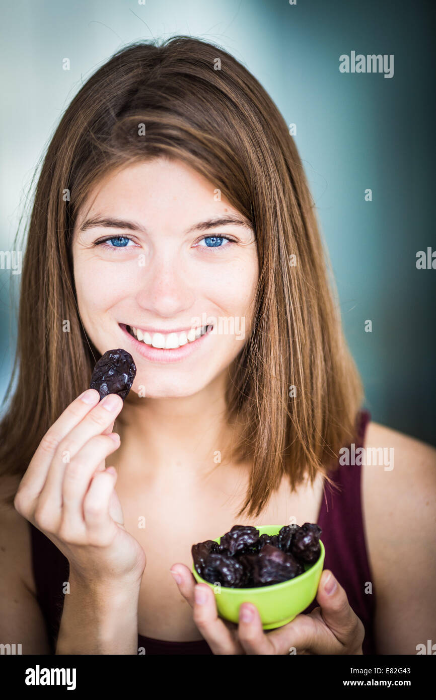 Woman eating prunes Stock Photo Alamy