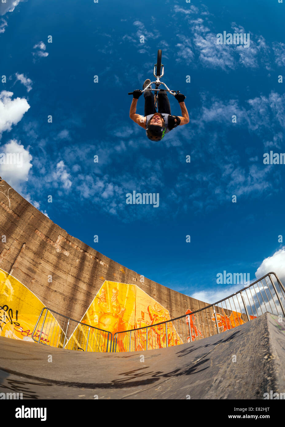 Germany, Young man performing stunt on BMX bike Stock Photo