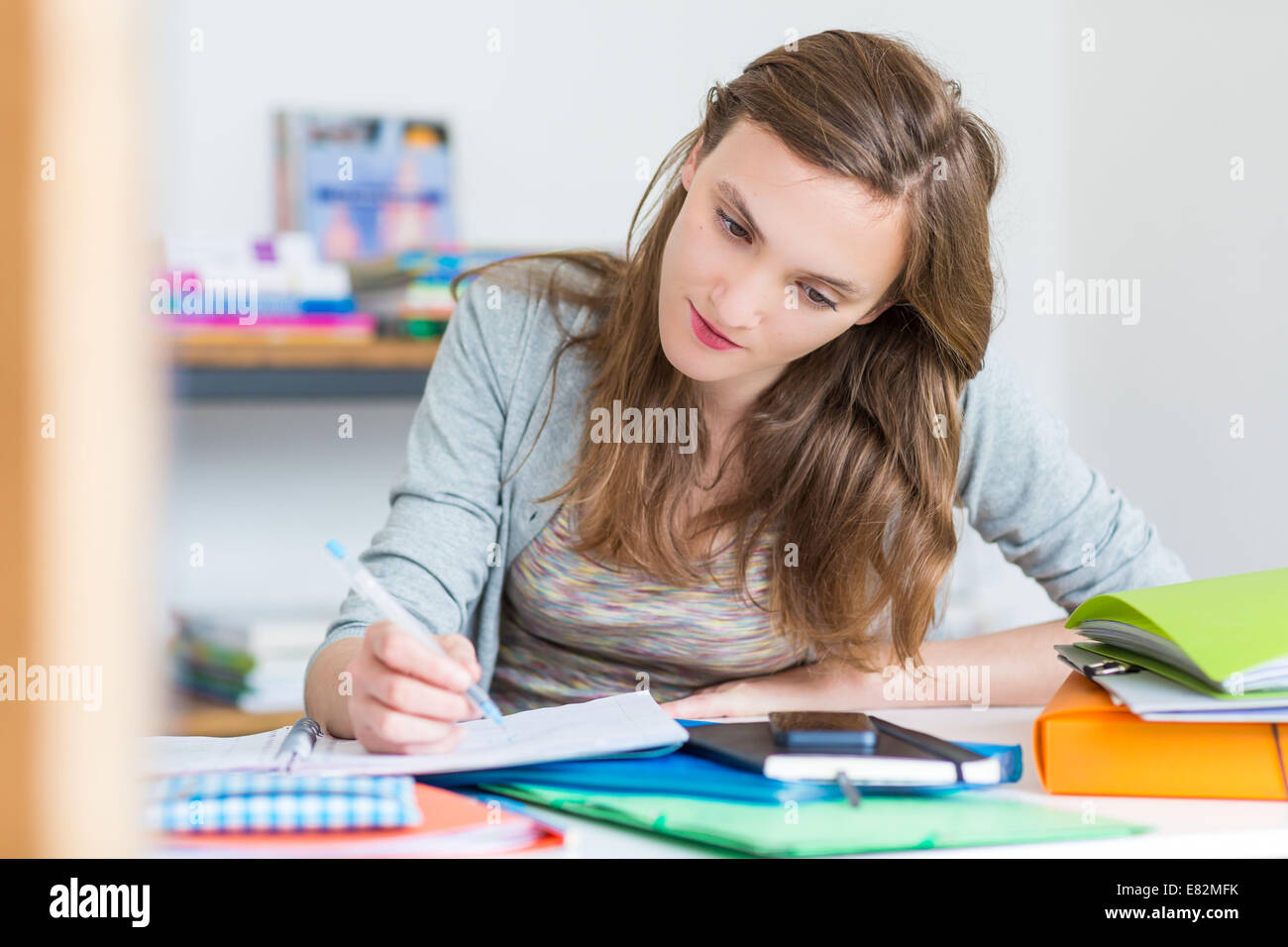 Teenage girl revising exams. Stock Photo