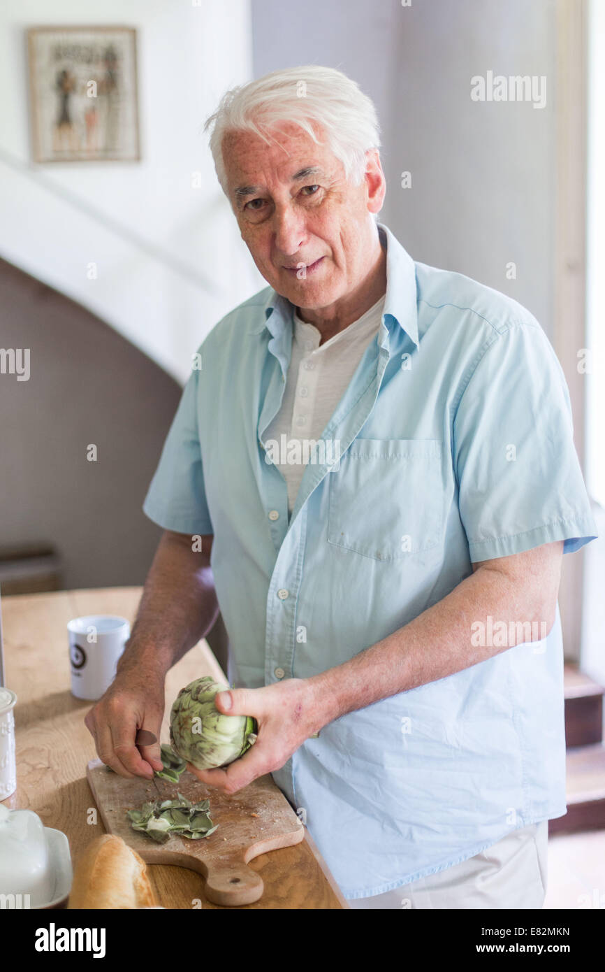 Man preparing artichokes. Stock Photo