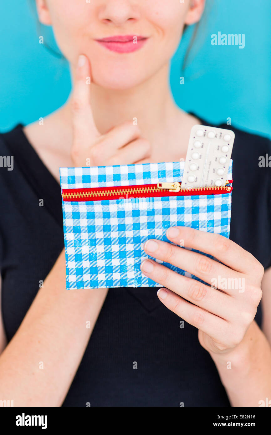 Woman holding contraceptive pills. Stock Photo