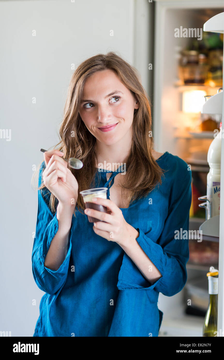 Woman eating yoghurt with chocolate. Stock Photo
