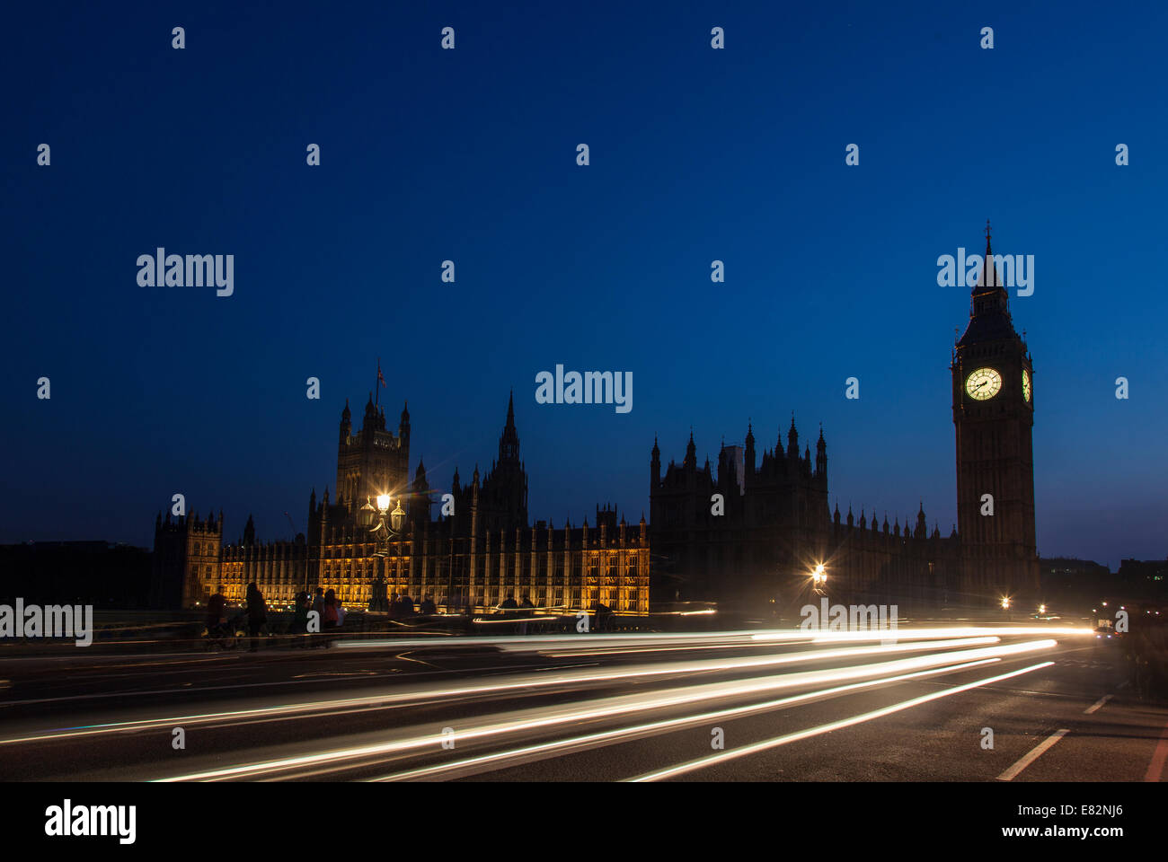 Night silhouette of Big Ben and light trail of a bus in front. Stock Photo