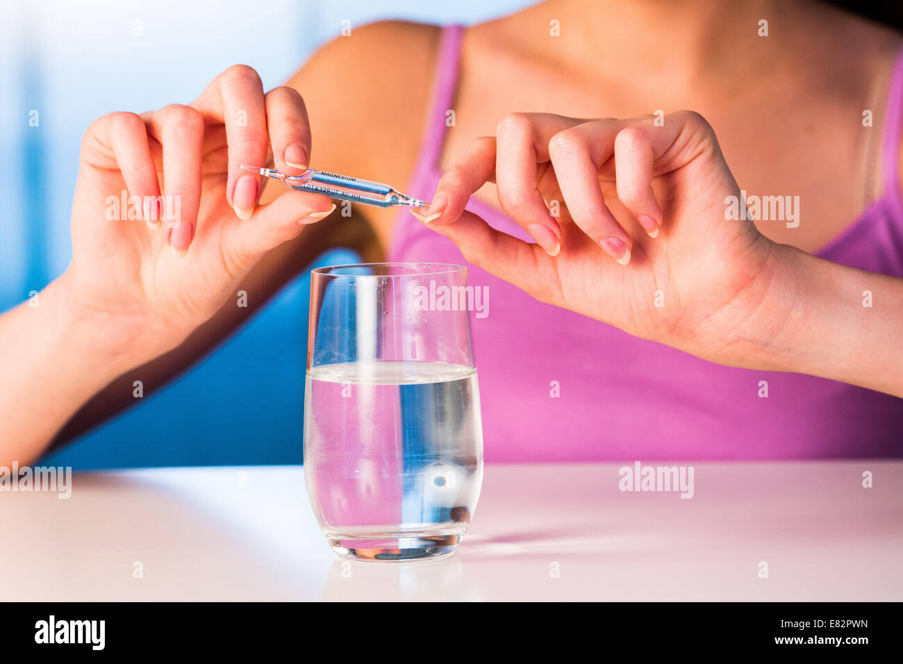 Woman holding glass ampoules of trace elements. Stock Photo