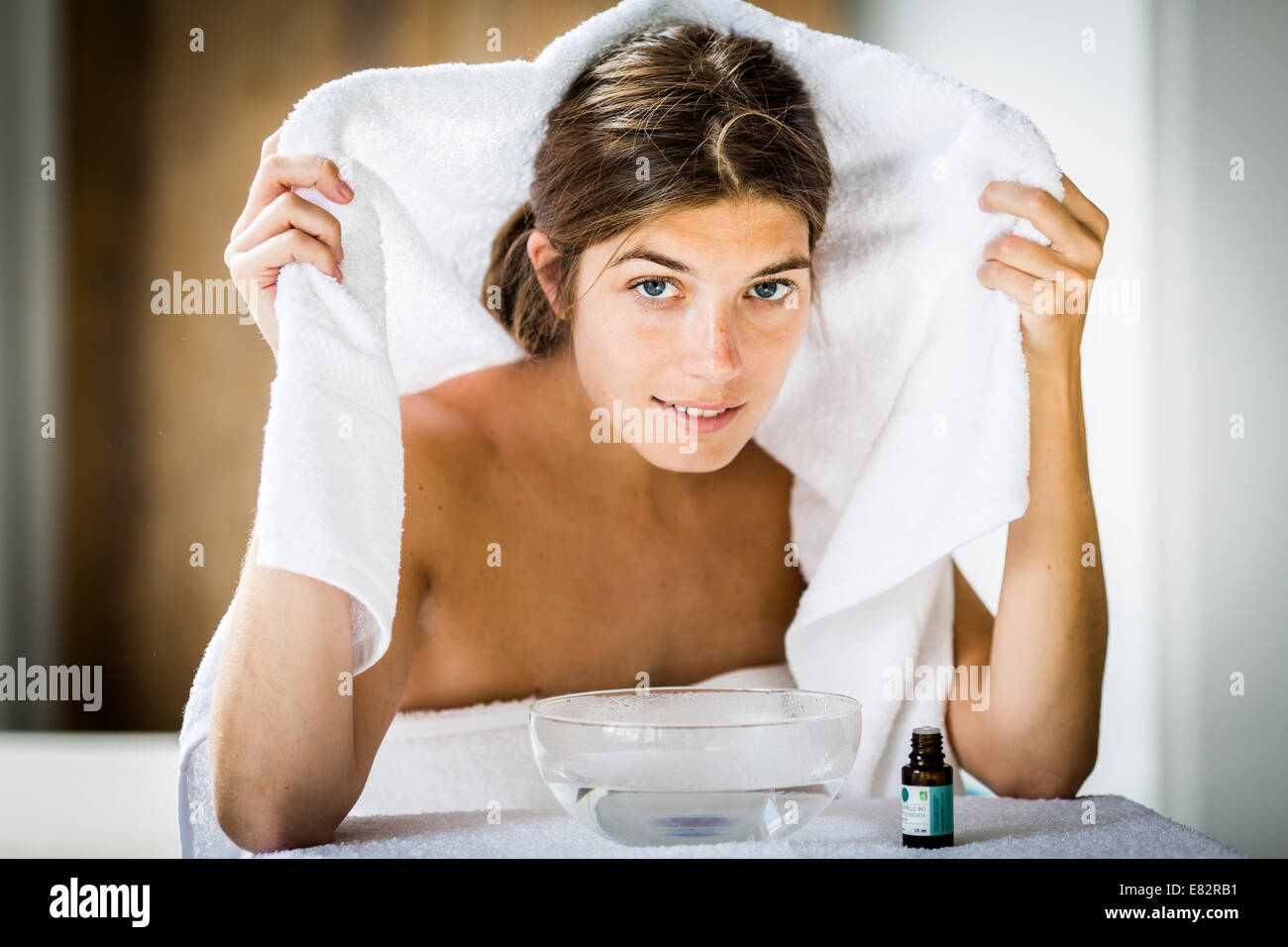 Woman treating a nasal congestion with an inhalation. Stock Photo