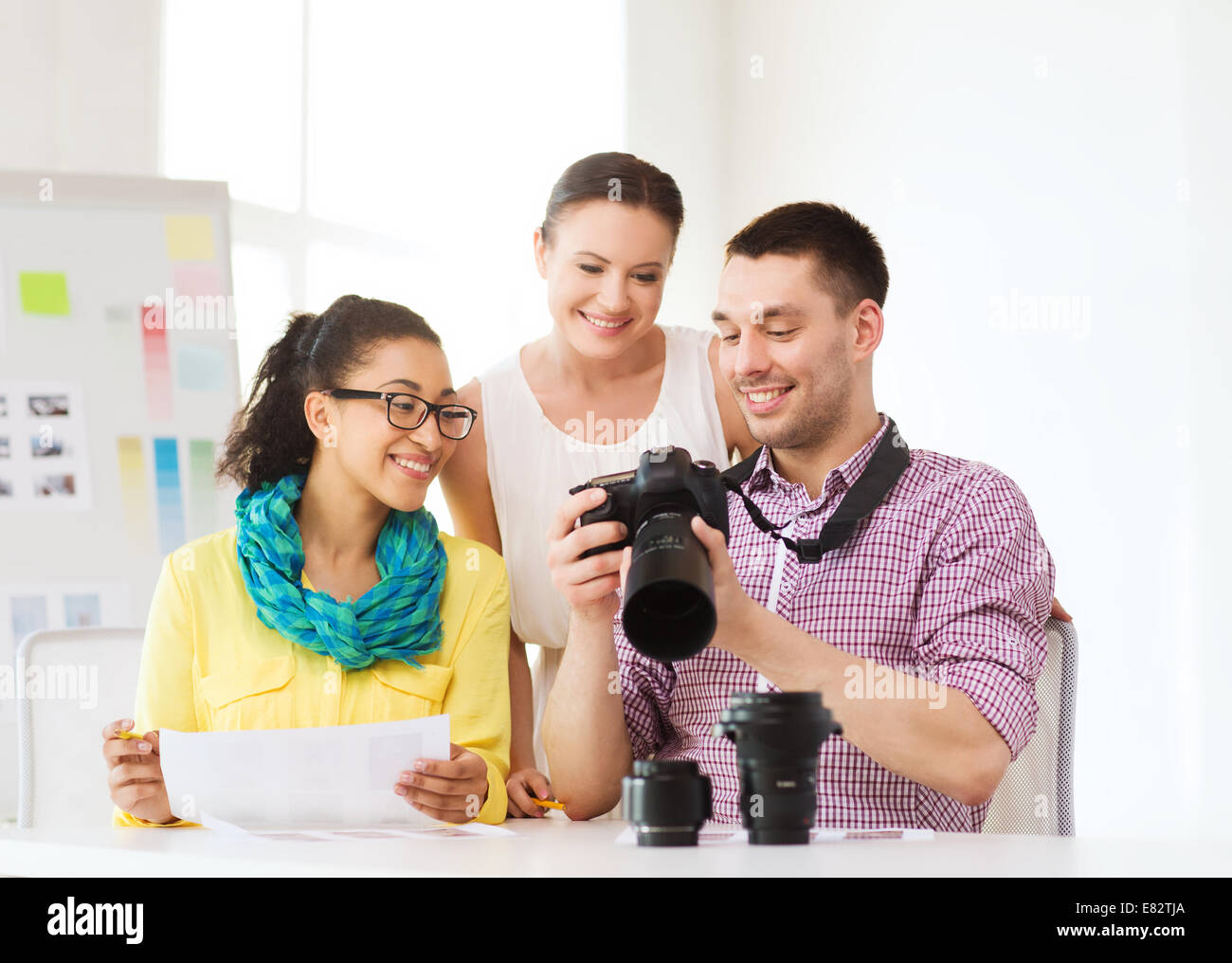 Team Photo Camera smiling team with photocamera working in office Stock Photo - Alamy