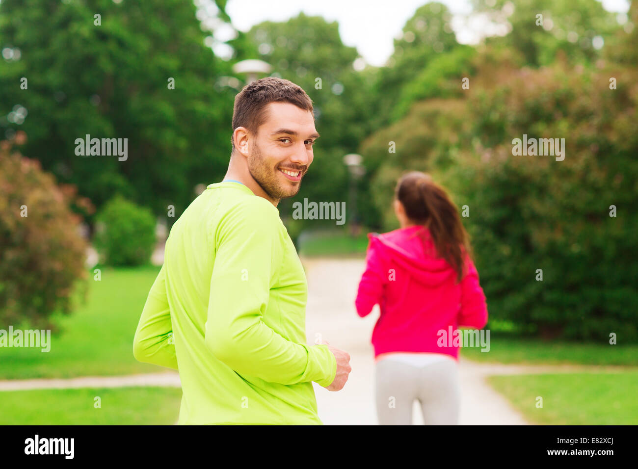 smiling couple running outdoors Stock Photo - Alamy