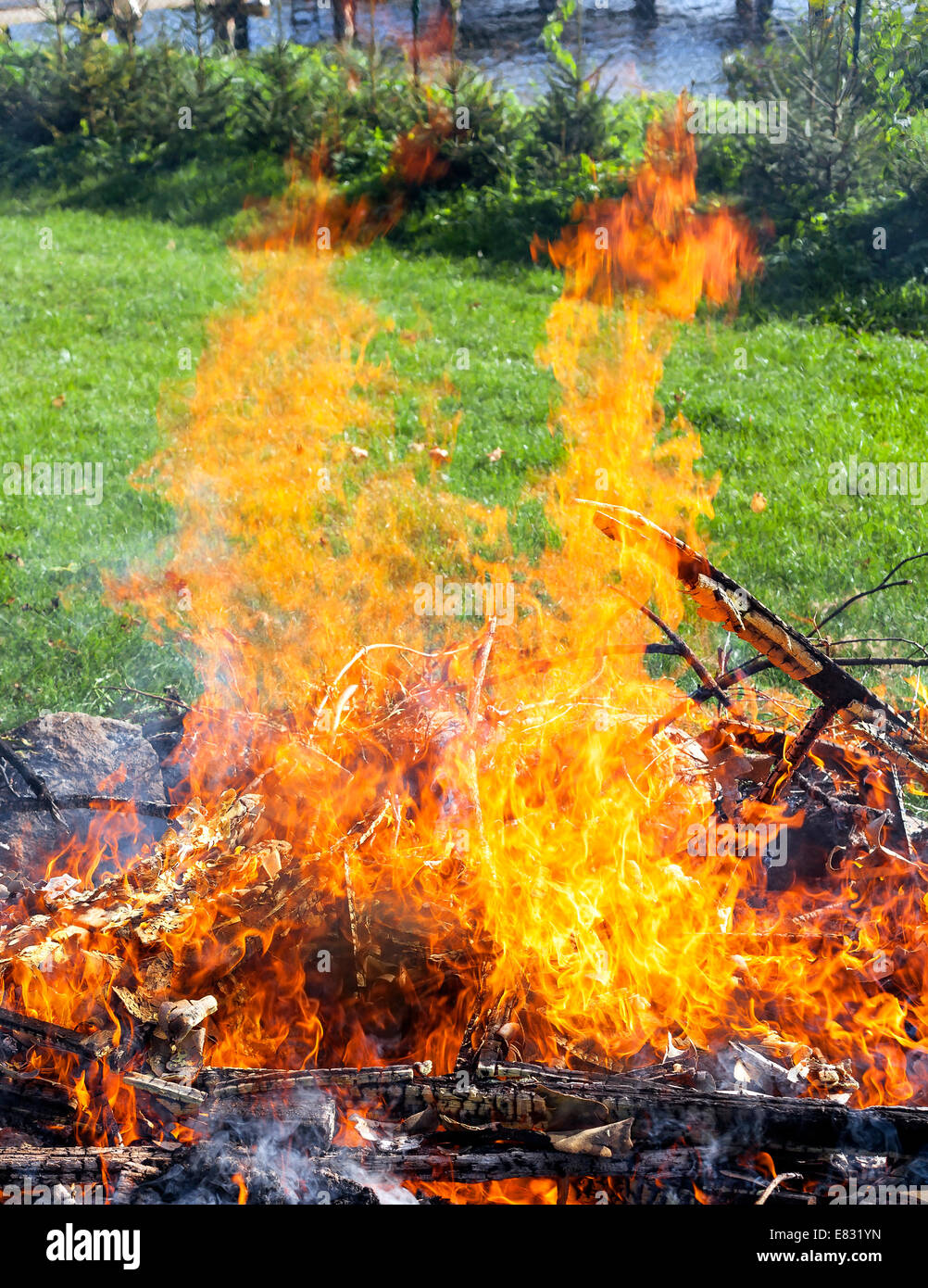 Garbage in fire, illegal garden burning out. Stock Photo