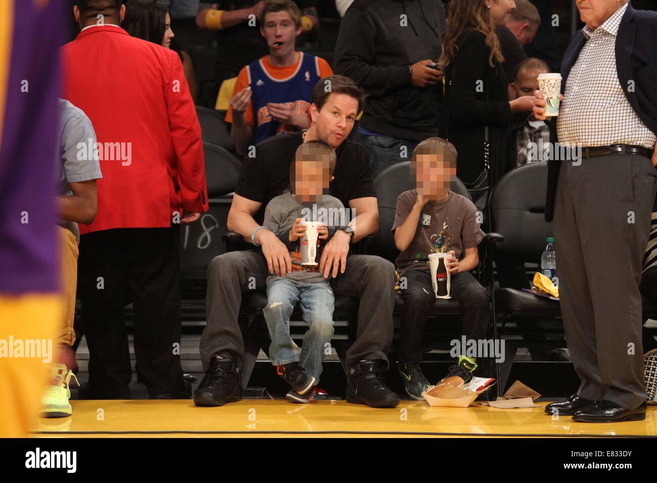 Celebrities at the Lakers game. The Los Angeles Lakers defeated the New York Knicks by the final score of 127-96 at Staples Center  Featuring: Mark Wahlberg,Brendan Joseph Wahlberg,Michael Robert Wahlberg Where: Los Angeles, California, United States When: 25 Mar 2014 Stock Photo
