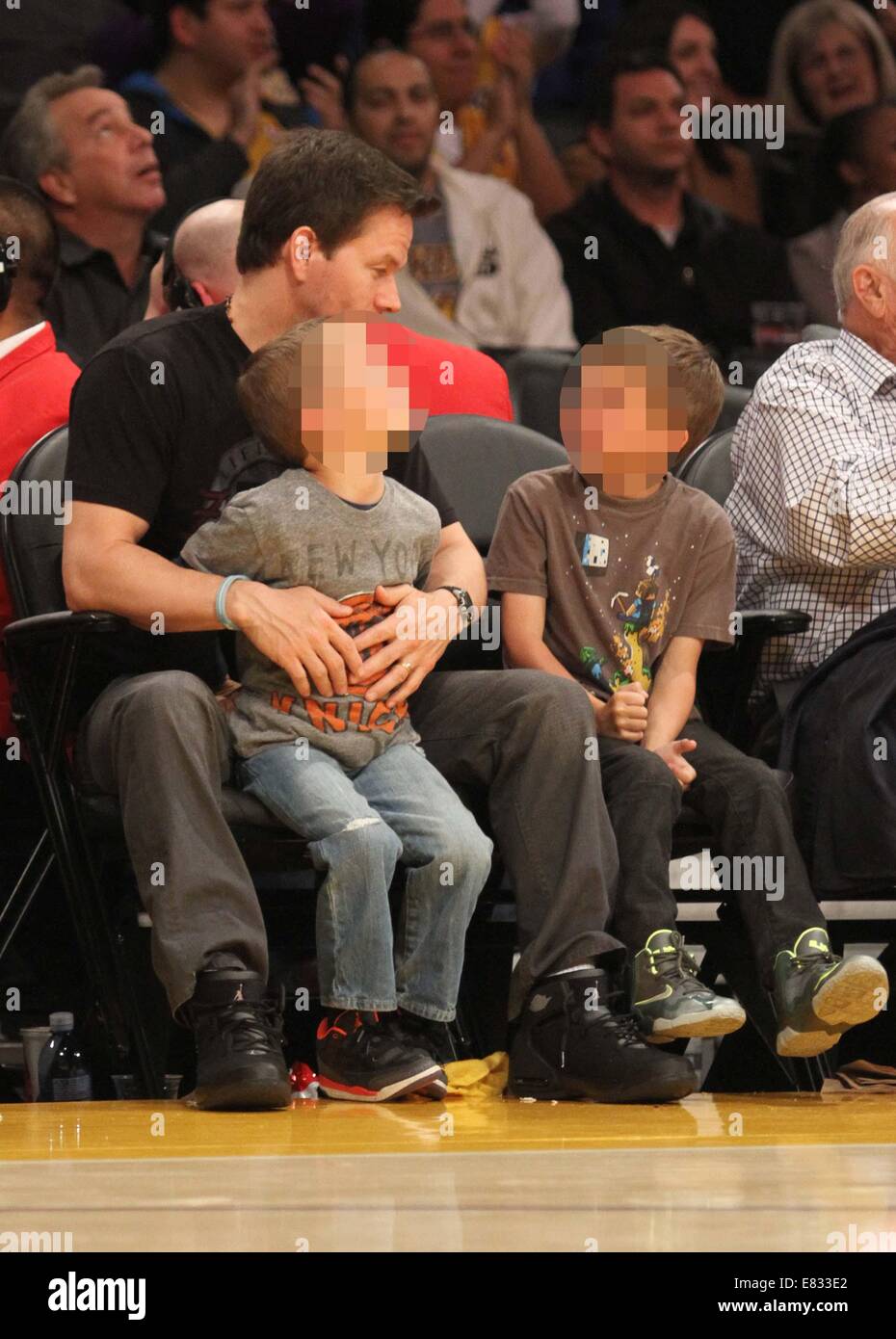 Celebrities at the Lakers game. The Los Angeles Lakers defeated the New York Knicks by the final score of 127-96 at Staples Center  Featuring: Mark Wahlberg,Brendan Joseph Wahlberg,Michael Robert Wahlberg Where: Los Angeles, California, United States When: 25 Mar 2014 Stock Photo