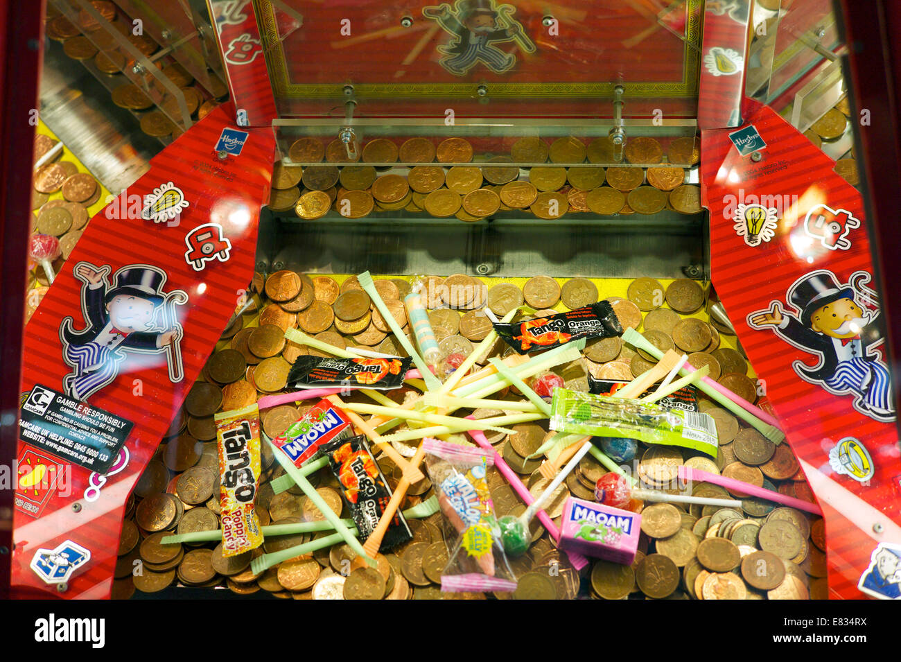 A 'coin pusher' slot machine in an amusement arcade, UK Stock Photo