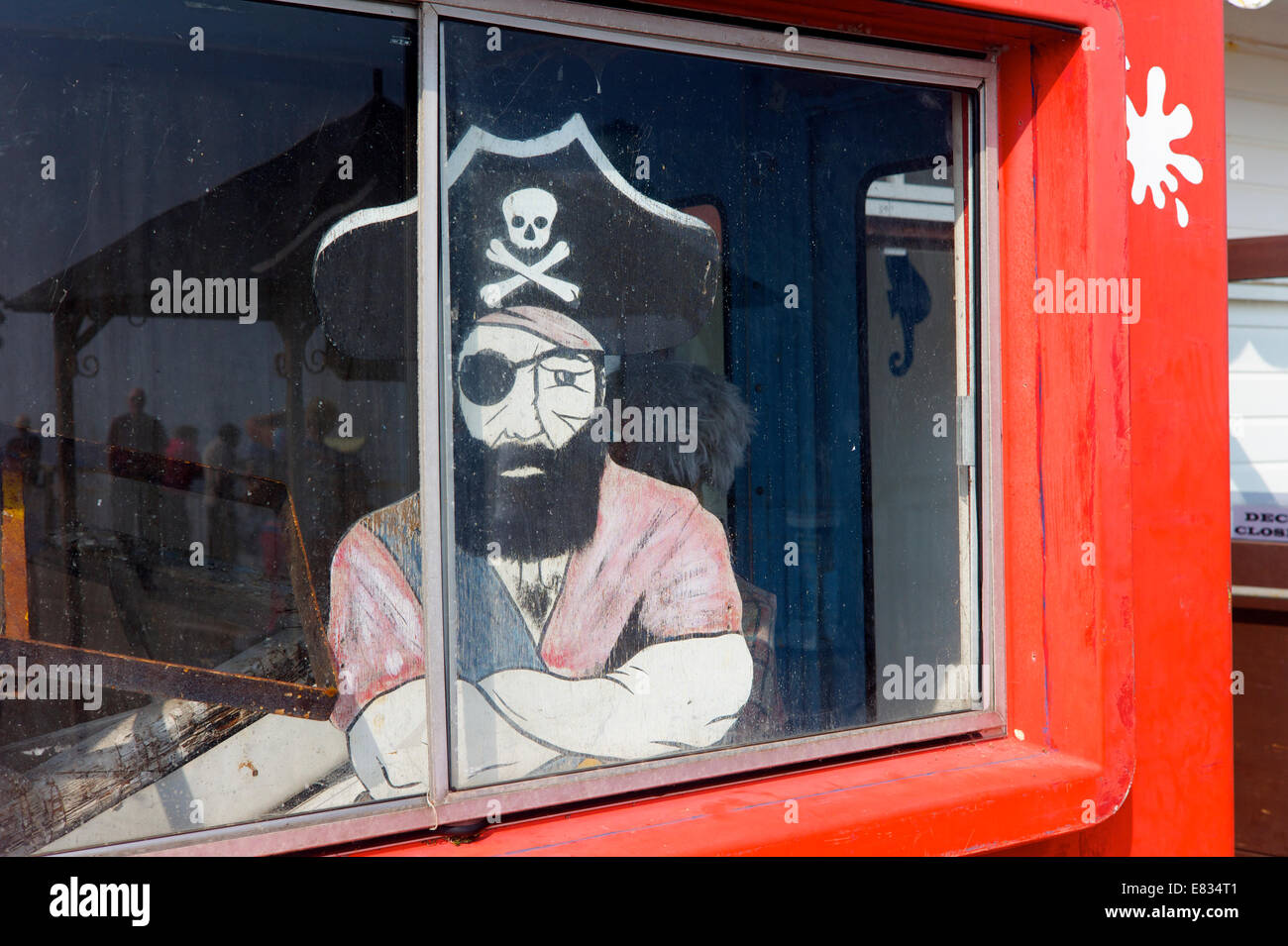 A pirate figure stares out at an amusement arcade, Devon, UK Stock Photo