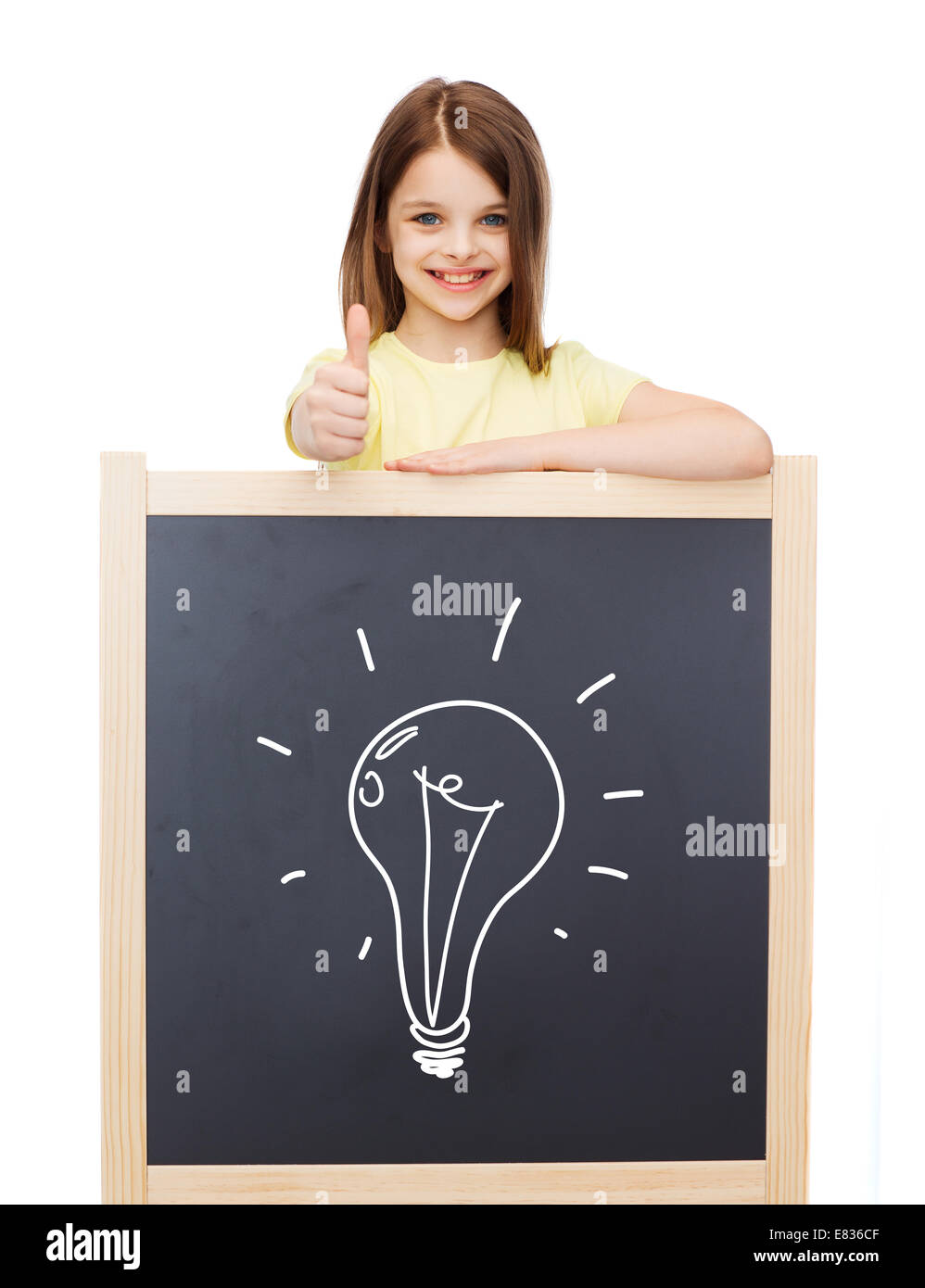 smiling girl with blackboard showing thumbs up Stock Photo