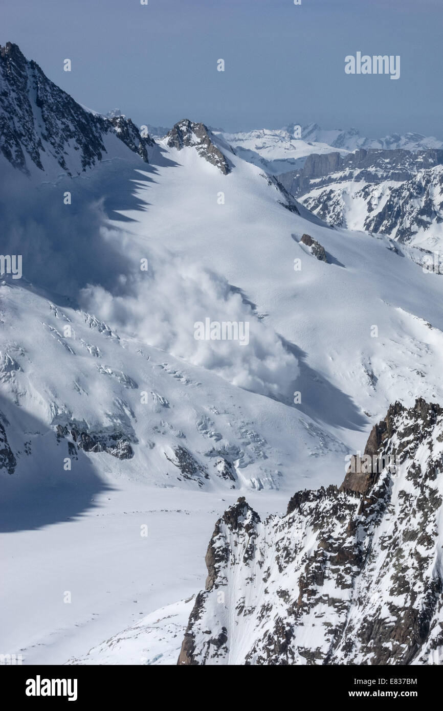 A massive avalanche triggered by serac fall thundering down towards Argentiere basin, Glacier Grandes Montents, Argentiere Stock Photo