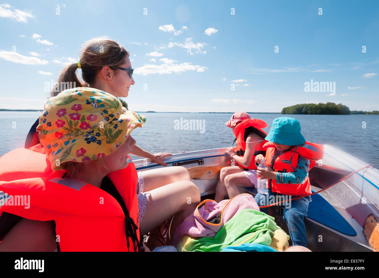 Mom with kids on a small boat Stock Photo