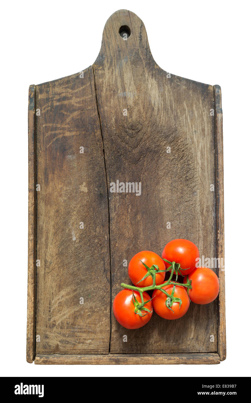 fresh red tomato branch on the vintage wooden cutting board Stock Photo ...