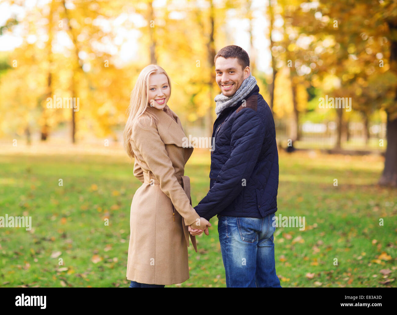 smiling couple in autumn park Stock Photo - Alamy