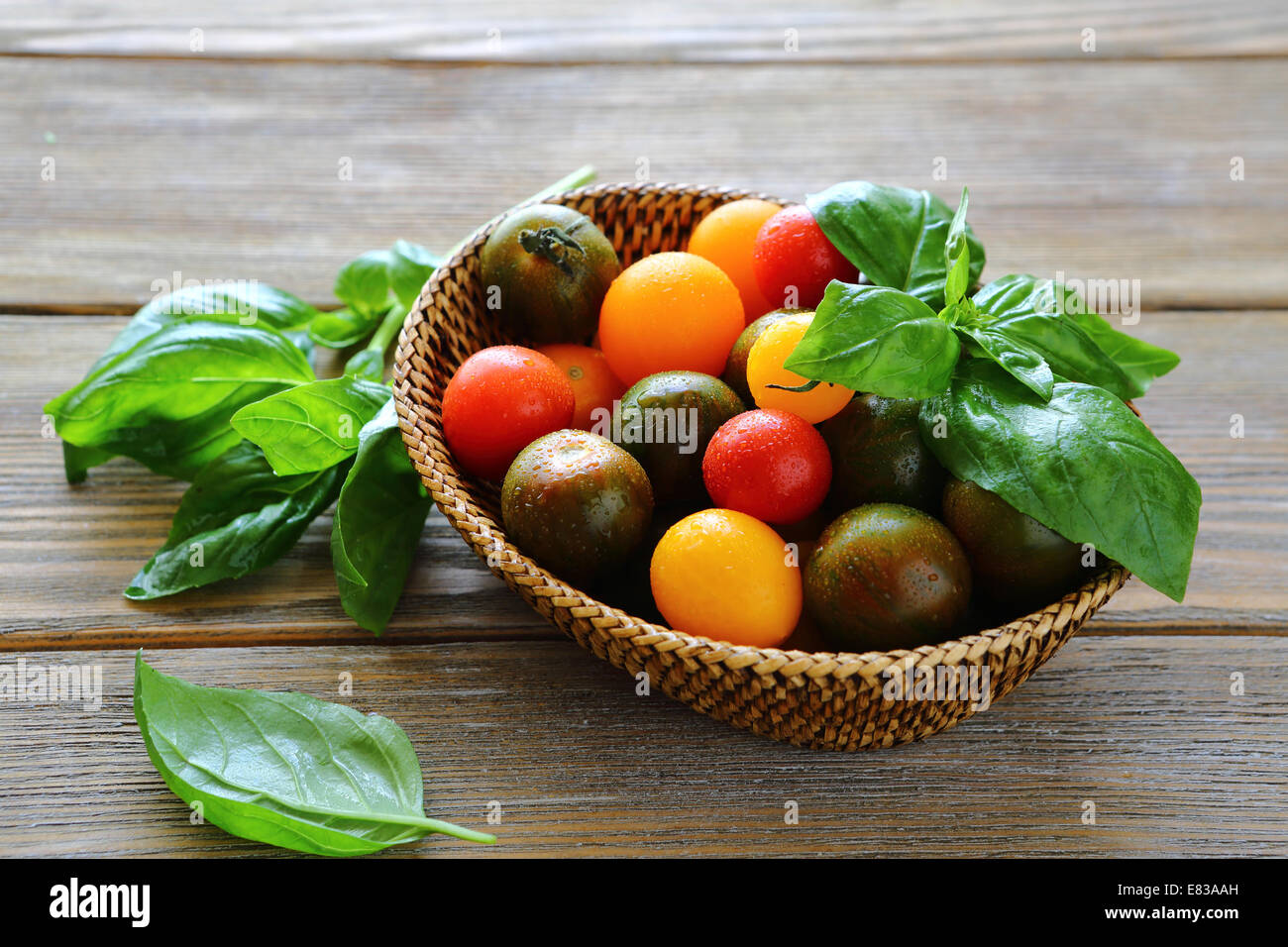 Cherry tomatoes in the wicker basket hi-res stock photography and ...
