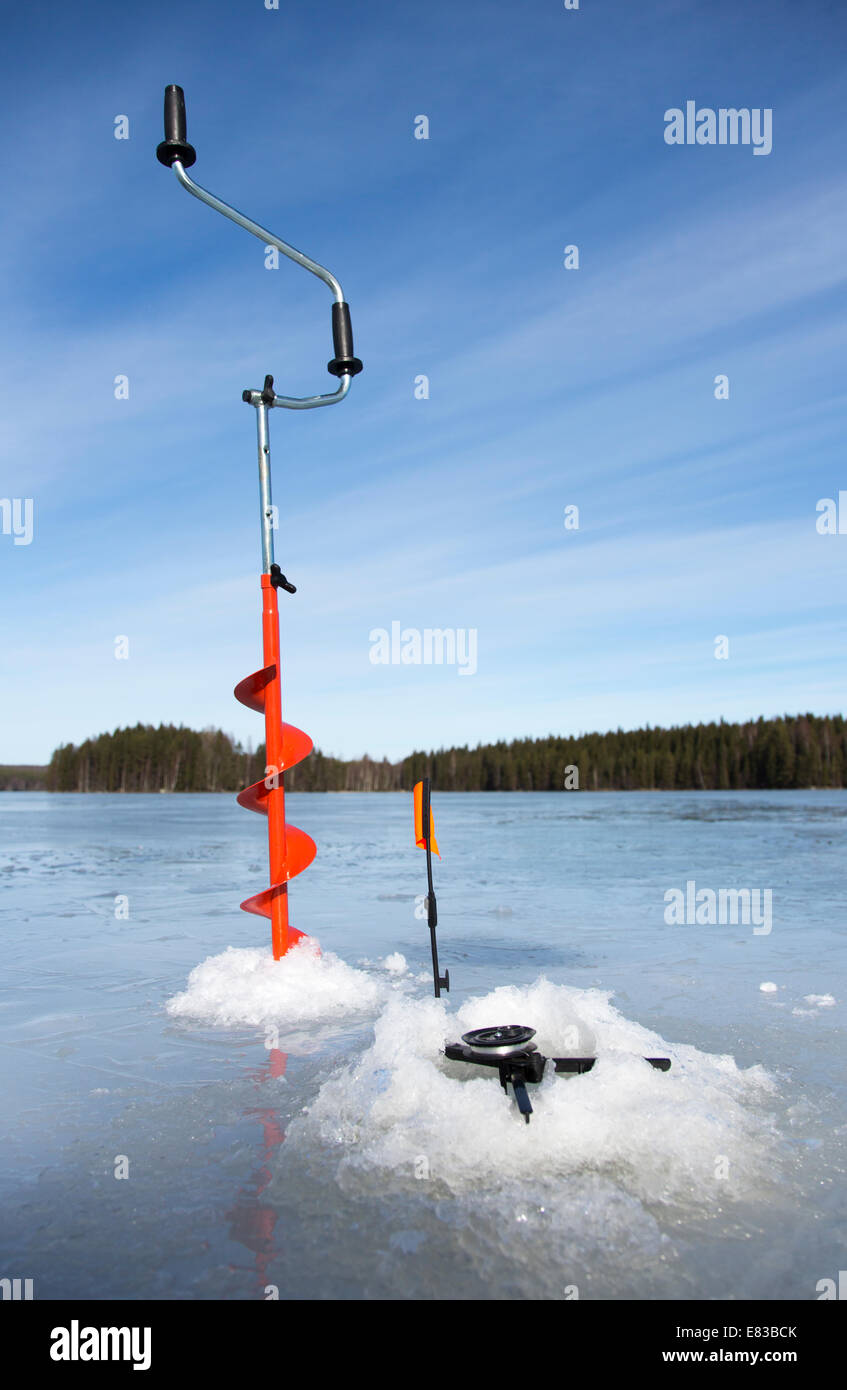 Isolated hand ice auger and tip-up ice fishing rod , Finland Stock
