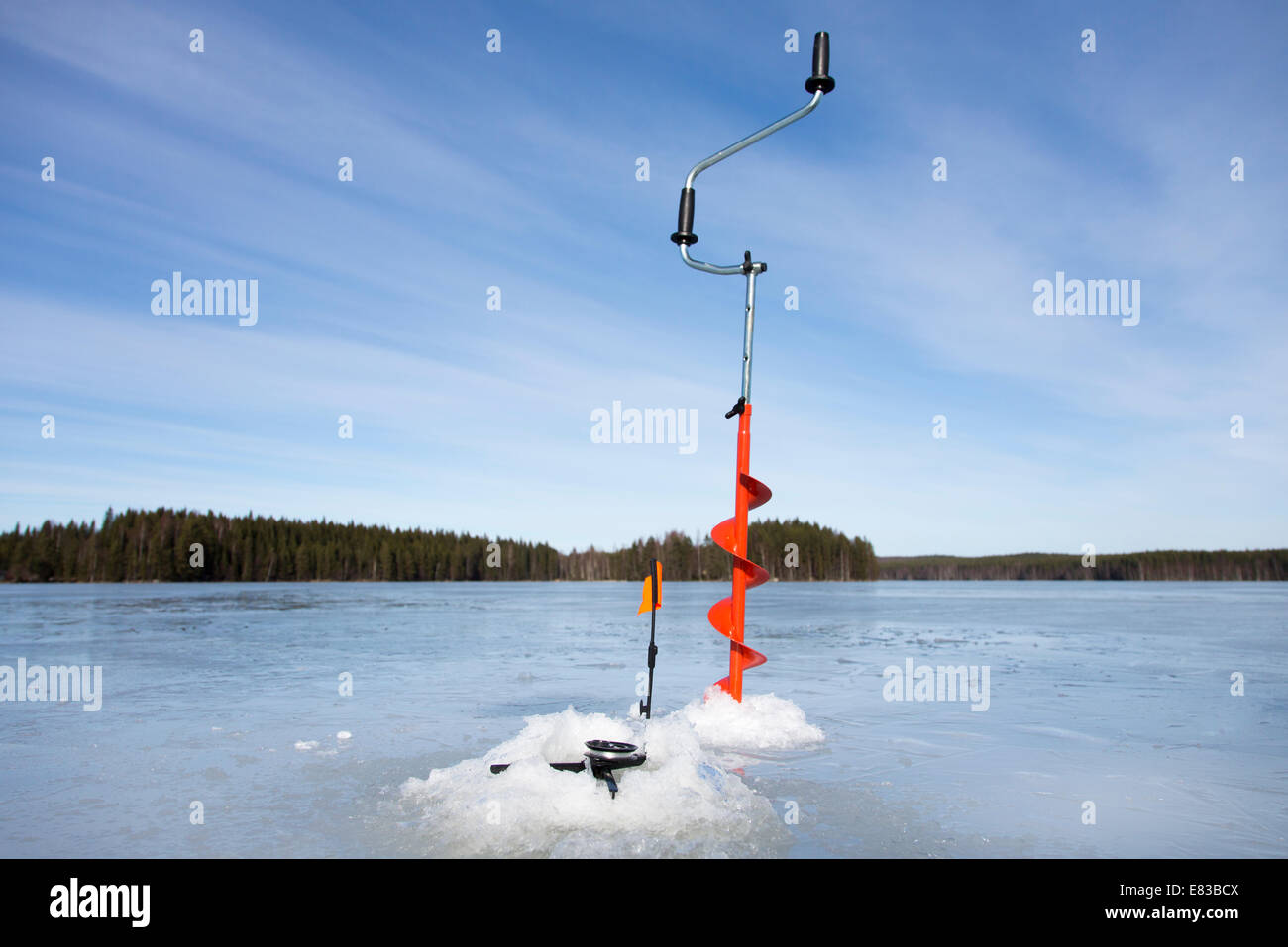 Hand ice auger and tip-up ice fishing rod at frozen lake at Winter ,  Finland Stock Photo - Alamy