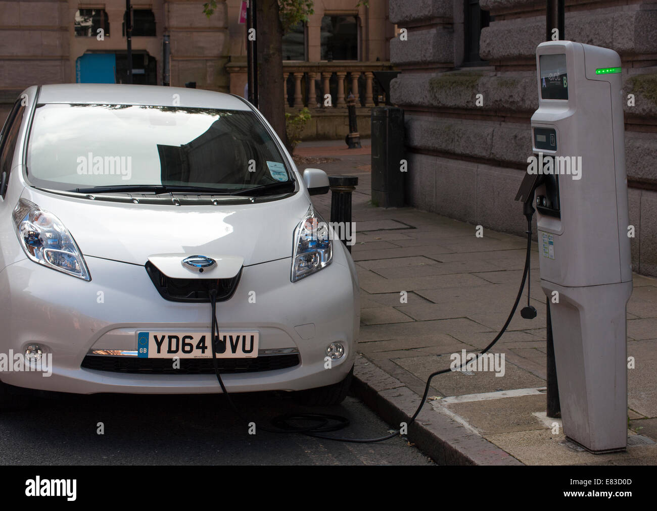 Electric car charging it's batteries at roadside charge point