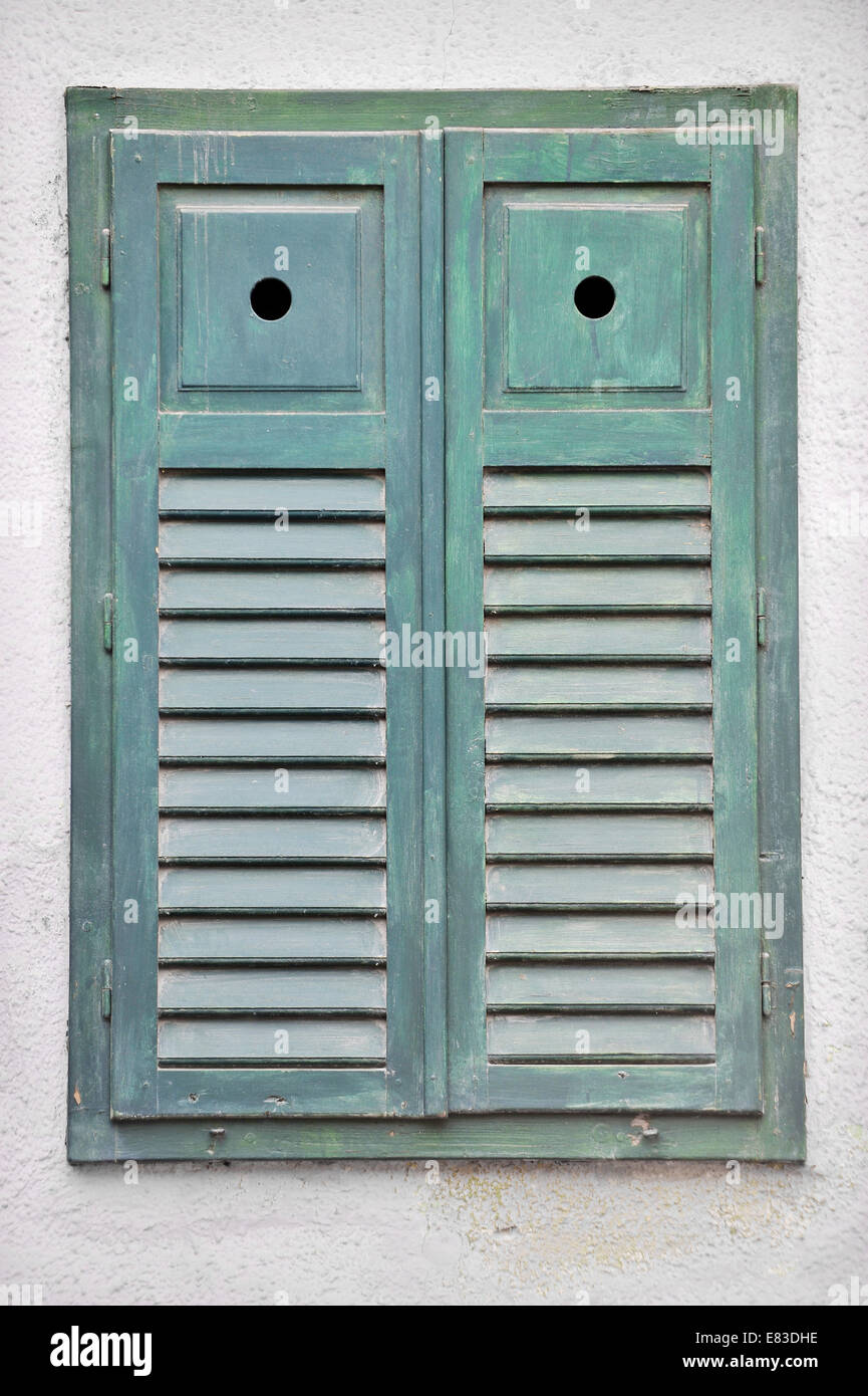 Architecture detail with closed green wooden window shutters Stock Photo