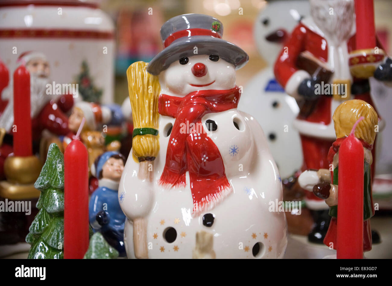 Christmas snowman china figurine decoration with other decorations made by Villeroy & Boch behind. Stock Photo