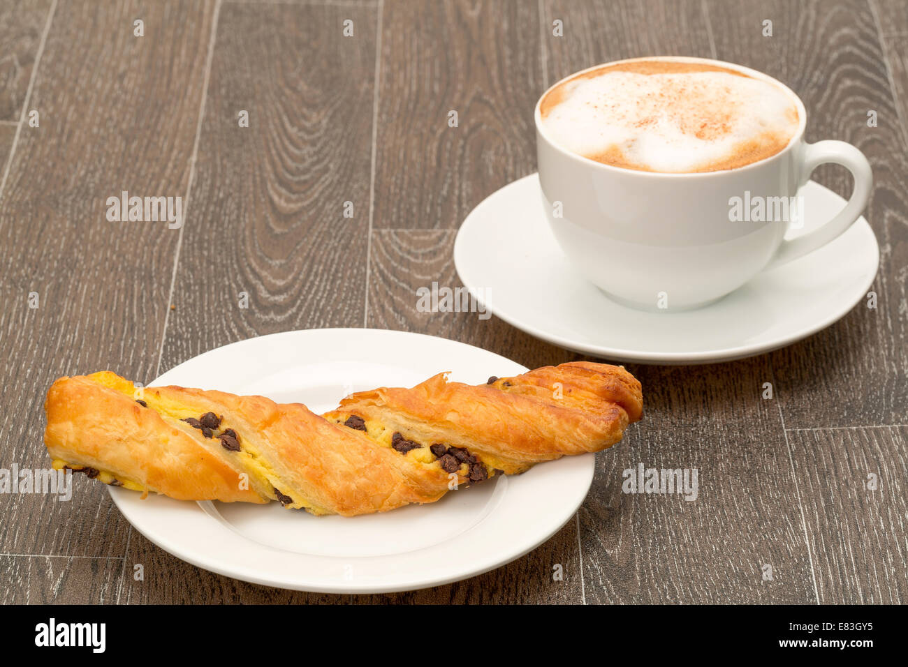 Authentic French chocolate twist pastry with a cappuccino coffee - studio shot Stock Photo