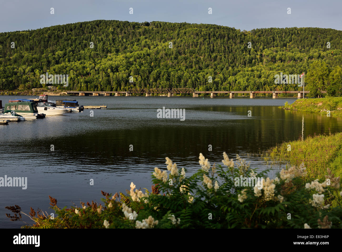 Train bridge over the Ottawa river to Quebec at Mattawa Explorers Point Park marina Ontario Canada Stock Photo