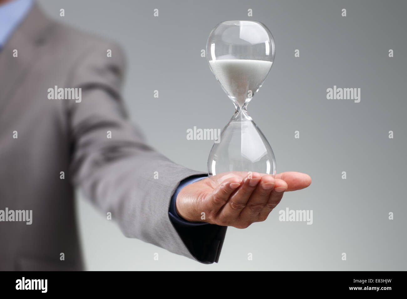 Businessman holding hourglass Stock Photo