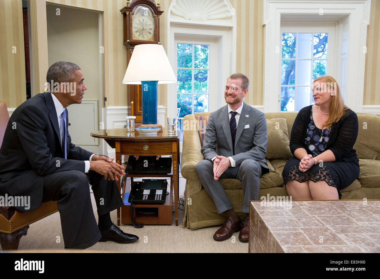 President Barack Obama meets with Dr. Kent Brantly and his wife, Amber, during an Oval Office drop by, Sept. 16, 2014.  Dr. Bran Stock Photo