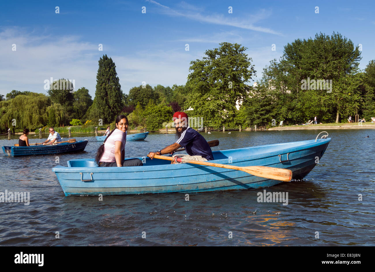 Young Sikh couple rowing on the boating lake in Regent's Park, London, England, UK Stock Photo