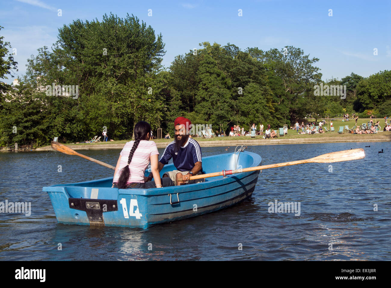 Young Sikh couple rowing on the boating lake in Regent's Park, London, England, UK Stock Photo